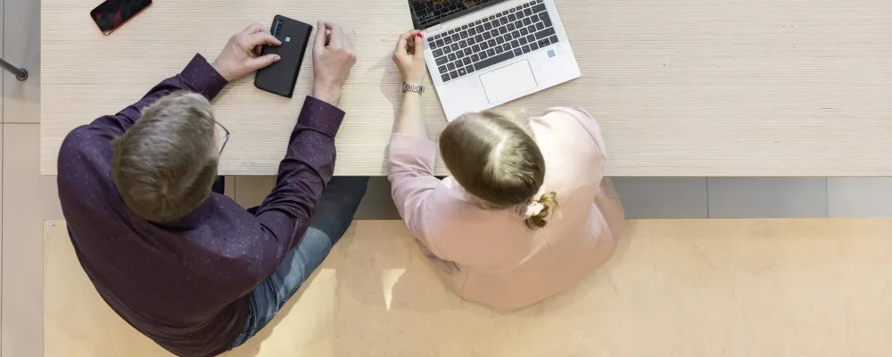People of different genders working at the same table