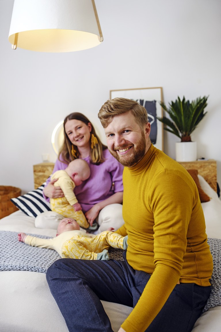 Maria Kultanen ja Lasse Heikkilä istuvat sängyllä kaksostensa kanssa.